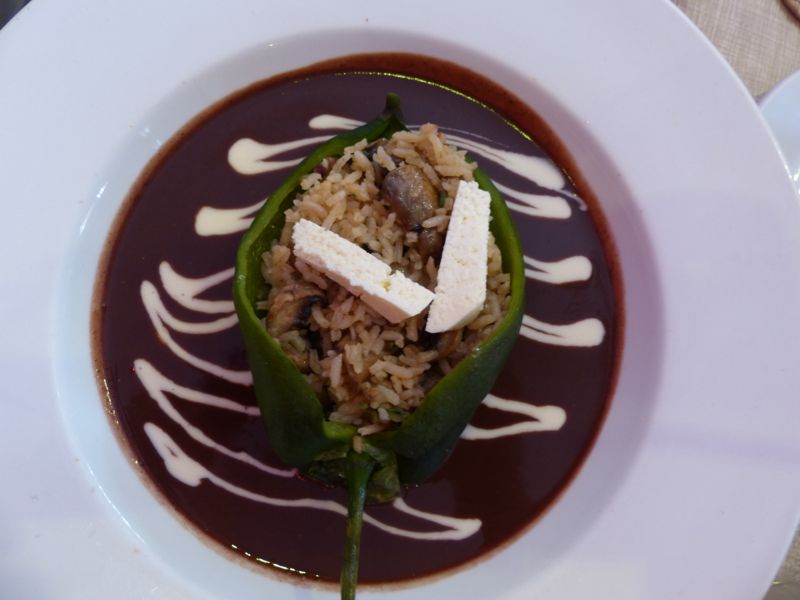 A stuffed poblano pepper with black bean sauce