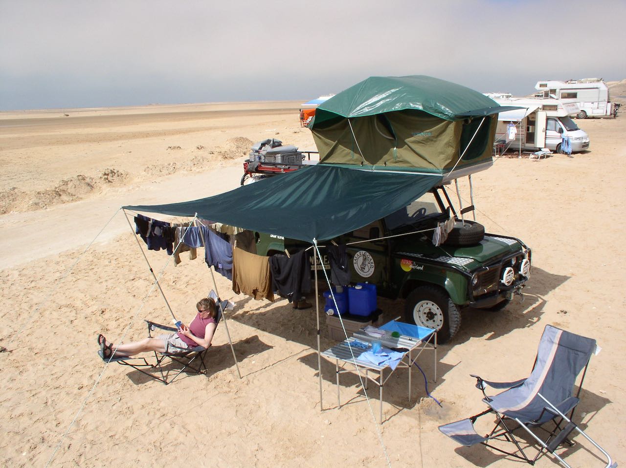 Relaxing in Western Sahara. This photo gives you an idea of the kind of gear that we had with us on our Africa trip. As much as we liked having shade, that awning was so difficult to set up that we hardly ever used it.
